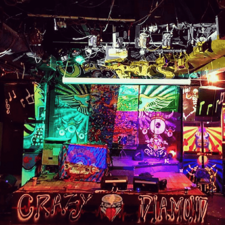 Colorful graffiti art and DJ setup at a vibrant party venue.